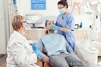 Stomatologist nurse putting oxigen mask before tooth surgery Stock Photo