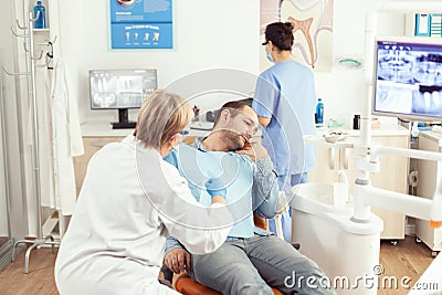 Stomatologist senior woman examining patient tooth pain during stomatology consultation Stock Photo