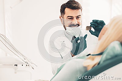 Stomatologist showing radiography to patient Stock Photo