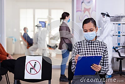 Stomatology patient in denstiry wainting area filling form Stock Photo