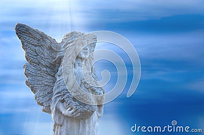 Stone angel statue in light beams Stock Photo