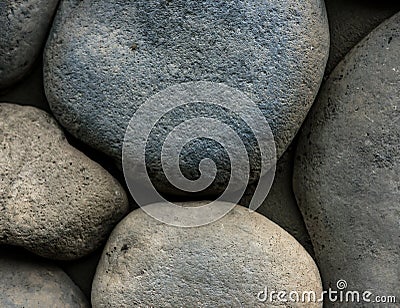 Stone background. Wall of rounded pebbles Stock Photo