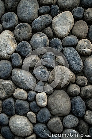 Stone background. Wall of rounded pebbles Stock Photo