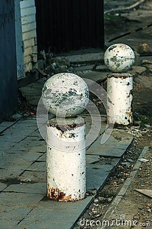 Stone balls on a city street. Urban design fencing road. Large outdoor decorative large cracks from natural granite spheres. Stock Photo