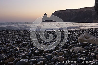 Stone beach close-up on the background of the rock going into the sea. Sunset on the beach Fiolent. Stock Photo