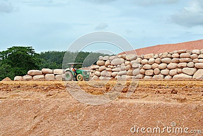 Stone boulders are stacked on the ground and used as retaining walls. Stock Photo