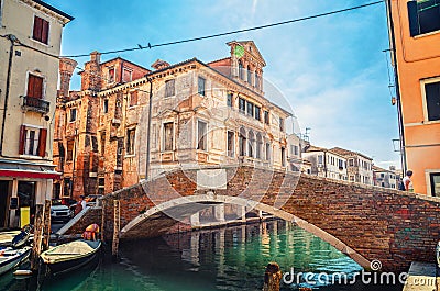 Stone brick bridge Ponte Caneva across Vena water canal in historical centre of Chioggia Stock Photo