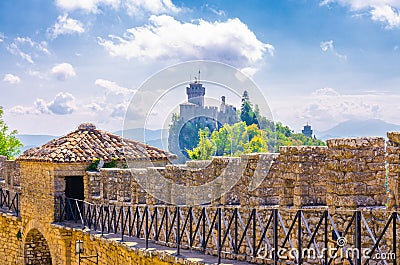 Stone brick fortress wall with merlons of Prima Torre Guaita first tower and Seconda Torre La Cesta second tower, San Marino Stock Photo