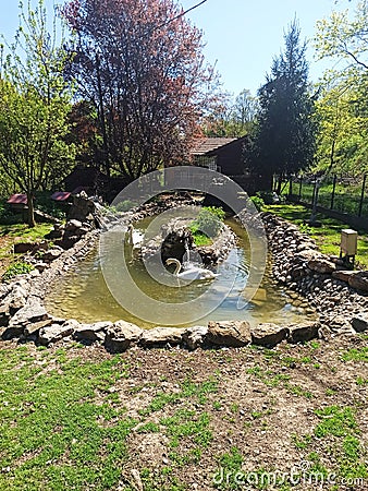 stone, brick swimming pool for swans, in the yard of Koporin Monastery, Serbia Stock Photo