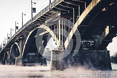 The stone bridge on the misty River Editorial Stock Photo