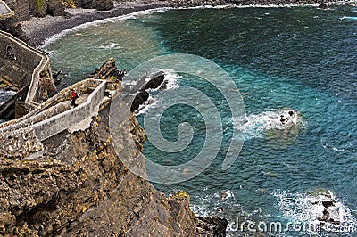 Stone bridge and narrow cliff trail above the Bay of Biscaya Stock Photo