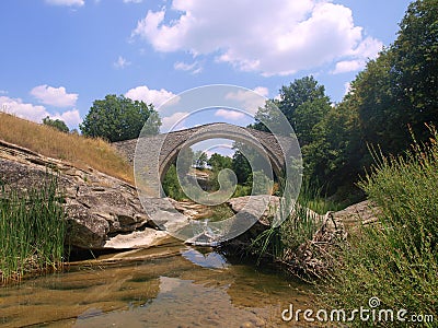 Stone bridge over creek Stock Photo