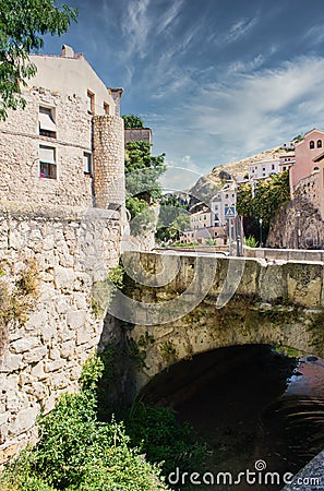 Stone bridge over the Huecar river as it passes through the city of Cuenca Stock Photo