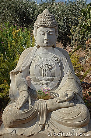 Stone Buddha Staue In Garden Stock Photo