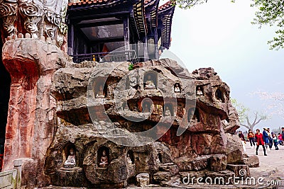 Stone Buddha on the stone wall at Wuxi Yuantouzhu - Taihu scenery garden, China. Editorial Stock Photo