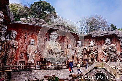Stone Buddha on the stone wall at Wuxi Yuantouzhu - Taihu scenery garden, China. Editorial Stock Photo