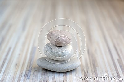 Stone cairn on striped grey white background, three stones tower, simple poise stones, simplicity harmony and balance, rock zen Stock Photo