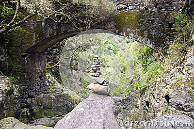 Stone cairn under the bridge, Rabacal, Madeira island, Portugal Stock Photo