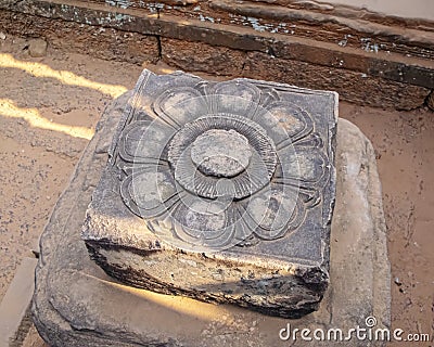 Stone carved as a lotus thought to be a place to make a fertility offering in the 10th-century, red sand stone, temple dedicated Editorial Stock Photo