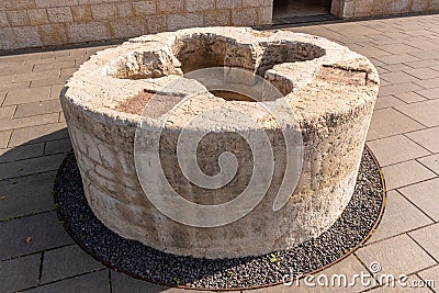 Stone carved Baptismal pool in front of at Tabgha or The Church of the Multiplication of the Loaves and Fishes Stock Photo