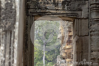Stone carved face of ancient buddhist temple Bayon in Angkor Wat complex, Cambodia. Ancient architecture Stock Photo