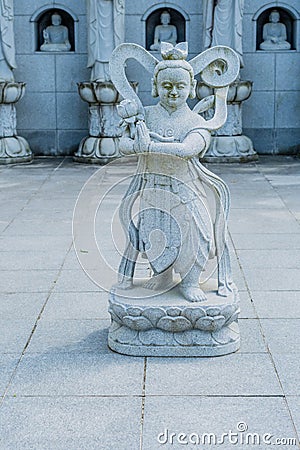 Stone carved statue of Buddhist guardian Stock Photo