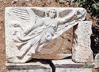 Stone carving of the goddess Nike at the ruins of ancient Ephesus, Turkey Stock Photo