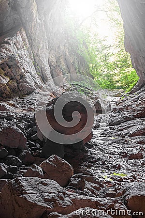 Stone cave inside view. Light exit Stock Photo