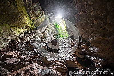 Stone cave inside view. Light exit Stock Photo