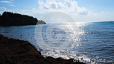 Stone coast on background of sea horizon in Sunny weather. Concept. Empty rocky coast with buoys and sun glare on water Stock Photo