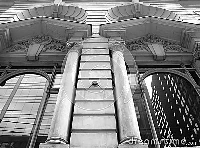 Stone Columns with windows that reflect the city Stock Photo