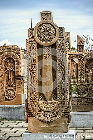 Stone cross carved with ornaments in the form of the twenty-ninth letter of the Armenian alphabet, created by Mesrop Mashtots in Editorial Stock Photo