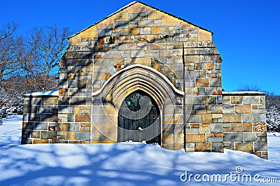 Stone Crypt in Snowy Cemetery Stock Photo