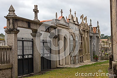 Stone crypts and columbarium with cross in european cemetery. Memory and death concept. Peace and sorrow concept. Stock Photo