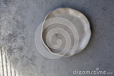 Stone curl gray platter on conrete table Stock Photo