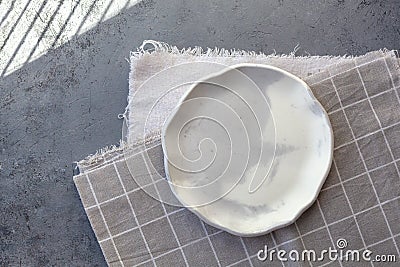 Stone curl gray platter on conrete table Stock Photo