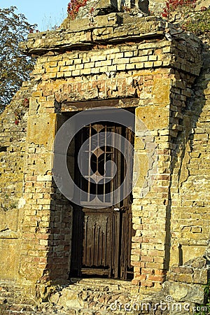 Stone curve Ruins wall with decorate iron door Stock Photo