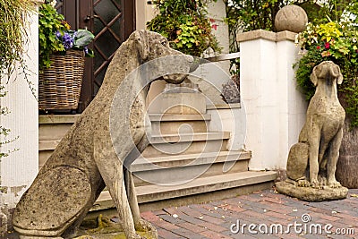 Stone dogs. Original garden decor. Animal figures in landscape design. Stock Photo