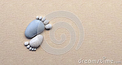 Stone feet from pebbles on the beach Stock Photo