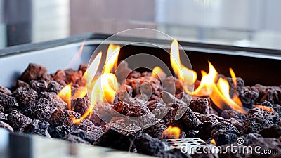 Stone firepit with fire flames. Summer camping bonfire Stock Photo