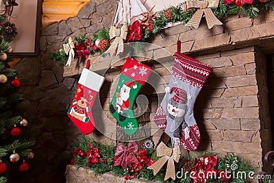 Stone fireplace decorated with christmas stockings Stock Photo