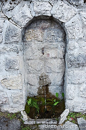 Stone fountain in Cadore, in Dolomiti region, noth Italy Stock Photo