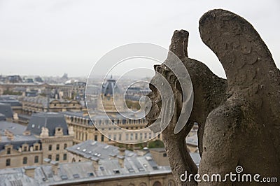 Stone gargoyle overlooking Paris from the Notre Dame Stock Photo