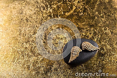 Stone with golden wings for a elegant background. Stock Photo