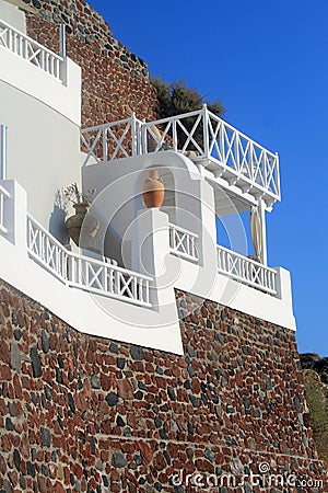 Stone greek house with white balcony, Santorini, Greece Stock Photo