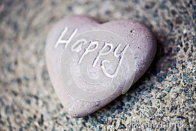 Stone heart with the word - Happy Stock Photo