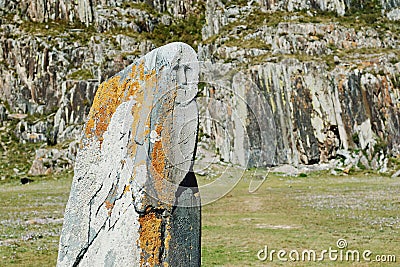Stone idol on a meadow surrounded by mountains, Altai, Russia Stock Photo