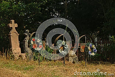 Stone and iron grave monuments in the Romanian countryside Editorial Stock Photo