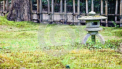 Stone Japanese lantern in a traditional oriental garden Stock Photo