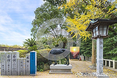 Stone lantern in front of a divine Shinme horse bronze statue in Japanese Miyajidake Shrine. Editorial Stock Photo